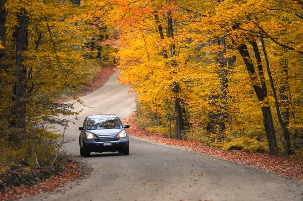 A modern car on a scenic road representing safety and freedom